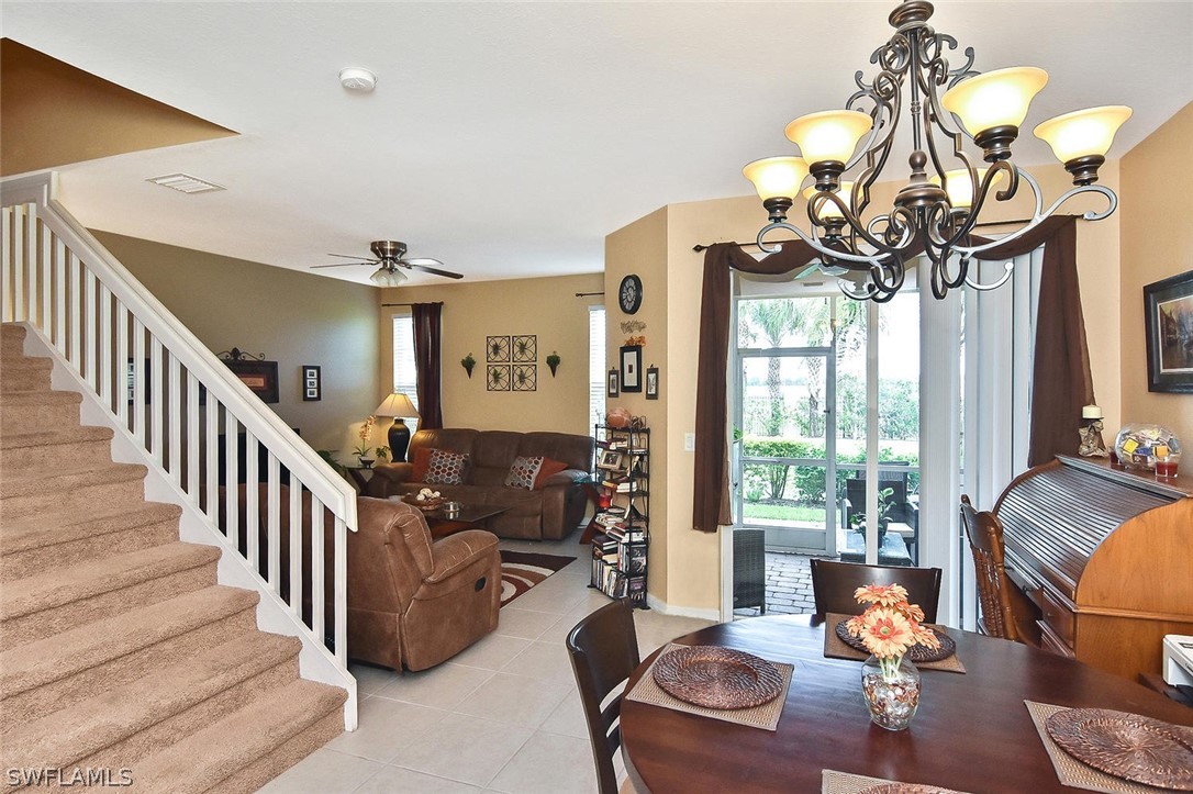 3840 Cherrybrook Loop Fort Myers, FL 33966 - Photo 15 of 32 a living room with furniture a chandelier and a fireplace