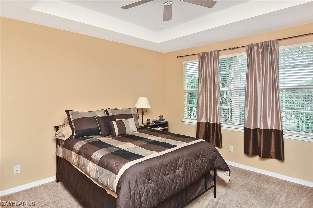 3840 Cherrybrook Loop Fort Myers, FL 33966 - Photo 17 of 32 a bedroom with a bed and a large window
