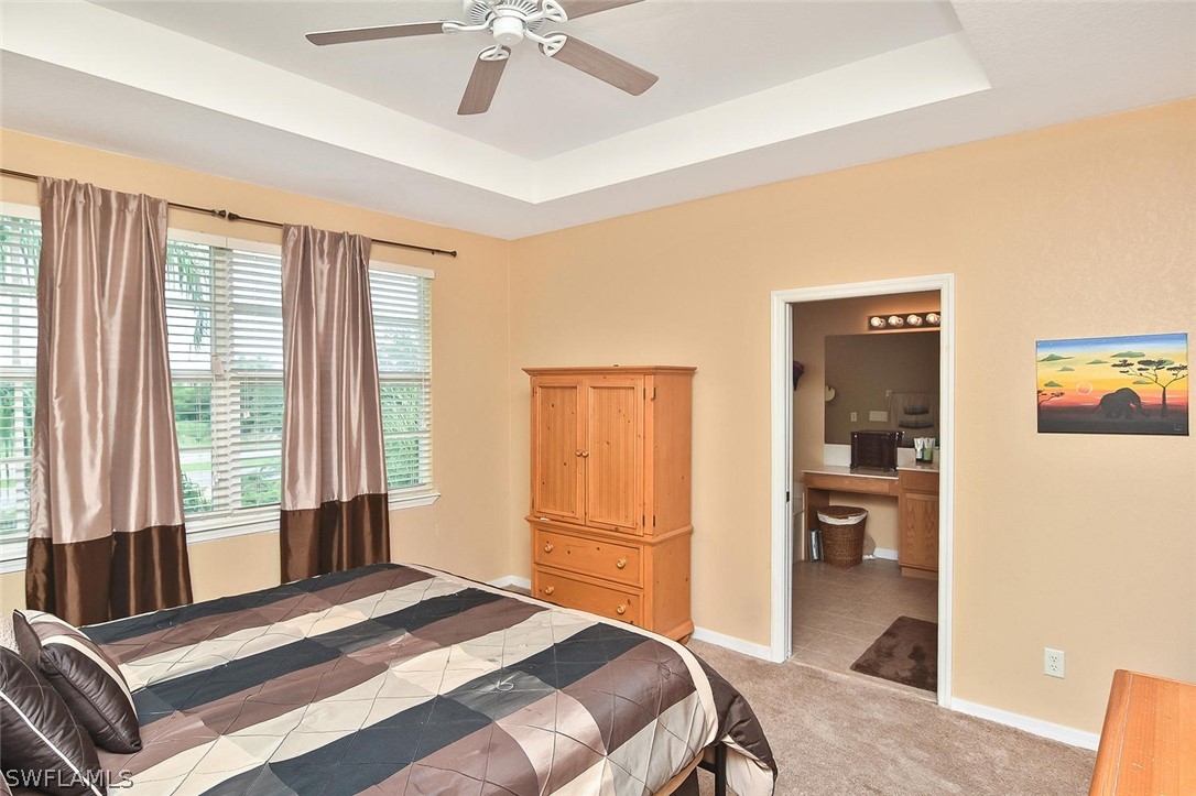 3840 Cherrybrook Loop Fort Myers, FL 33966 - Photo 18 of 32 a bedroom with a bed and a chandelier