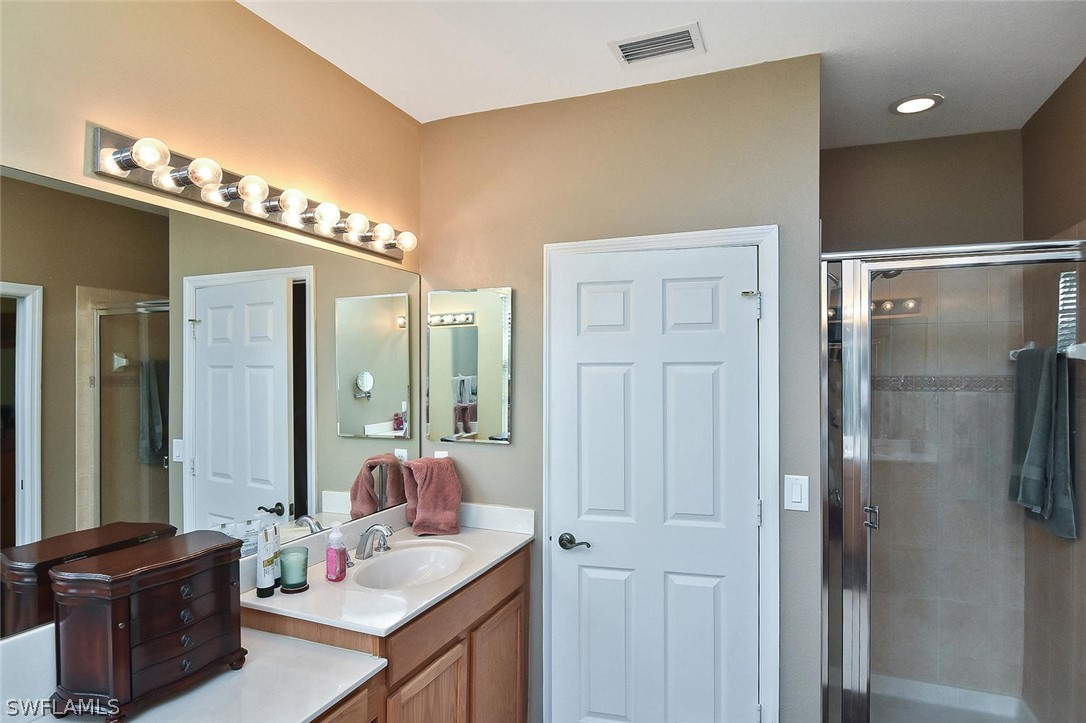 3840 Cherrybrook Loop Fort Myers, FL 33966 - Photo 20 of 32 a bathroom with a double vanity sink and mirror