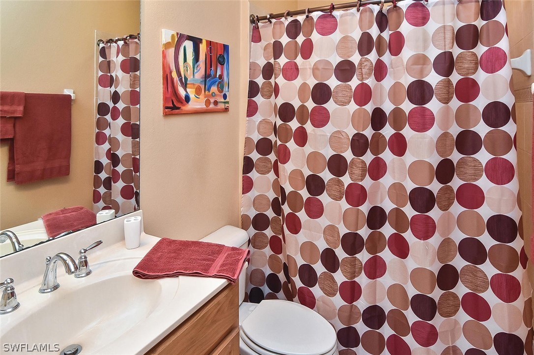 3840 Cherrybrook Loop Fort Myers, FL 33966 - Photo 22 of 32 a bathroom with a sink and mirror with toilet