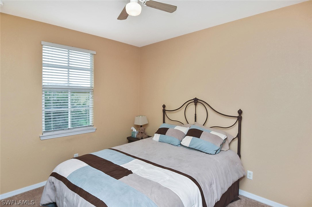 3840 Cherrybrook Loop Fort Myers, FL 33966 - Photo 23 of 32 a bedroom with a bed a dresser and window