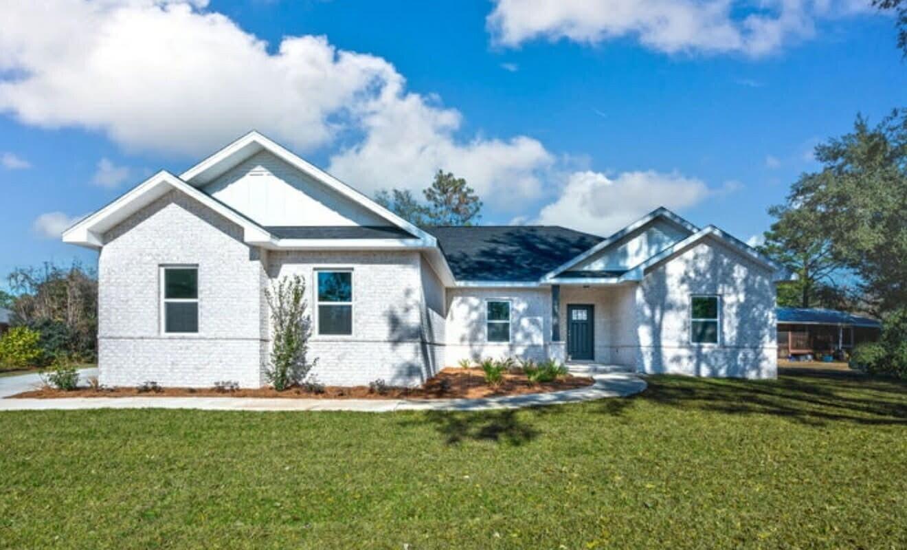 a front view of house with yard and green space