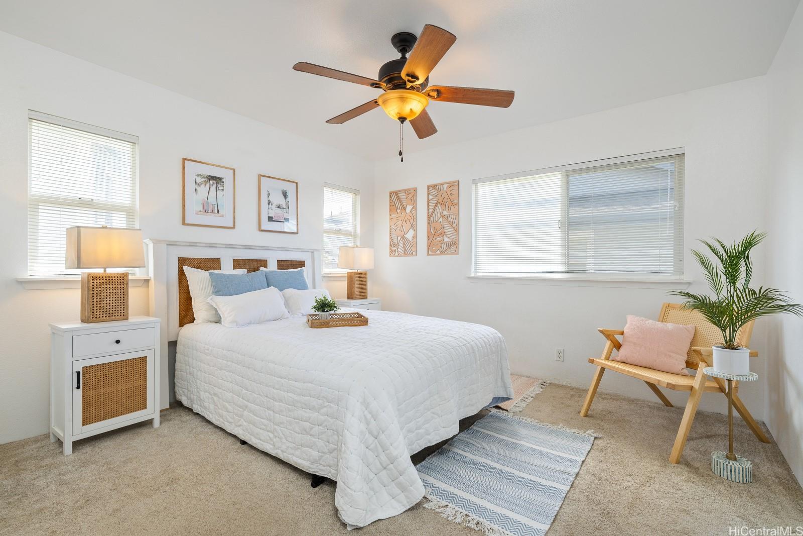 92-7049 Elele Street, Unit 22 Kapolei, HI 96707 - Photo 7 of 8 a bedroom with a bed and a chair