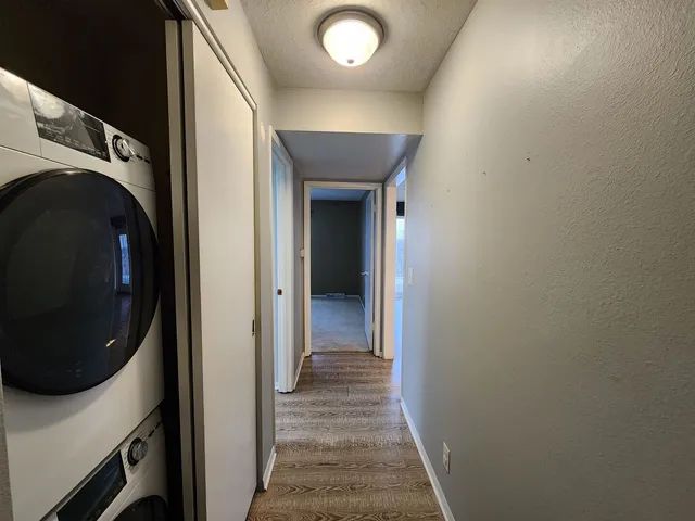 a view of a hallway with washer and dryer
