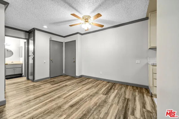 a view of an empty room with wooden floor