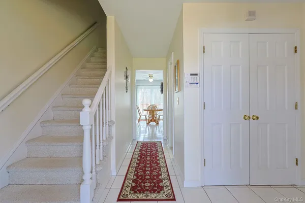 a view of a hallway with wooden floor and entryway