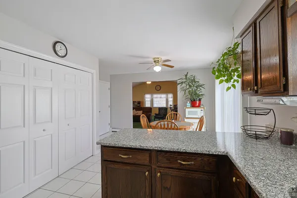 a kitchen with granite countertop a sink and cabinets