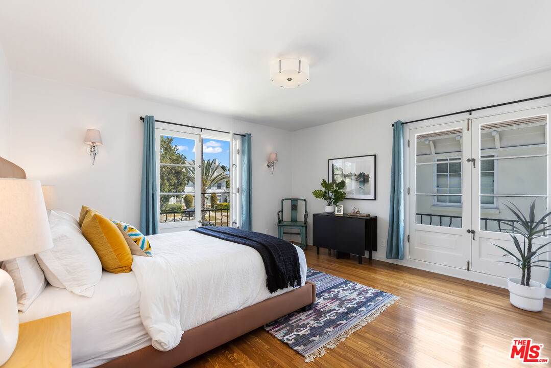 1743 Virginia Road Los Angeles, CA 90019 - Photo 44 of 75 a bedroom with a bed and wooden floor
