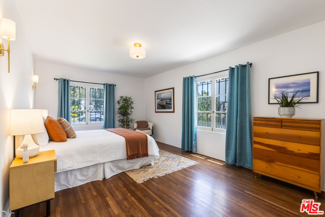 1743 Virginia Road Los Angeles, CA 90019 - Photo 54 of 75 a bedroom with a bed and wooden floor