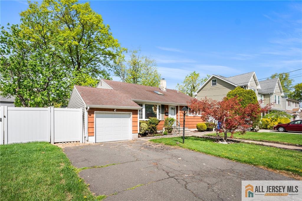 67 Drake Place Colonia, NJ 07067 - Photo 1 of 31 a front view of a house with a yard and garage