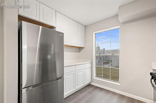 a kitchen with stainless steel appliances a refrigerator and cabinets