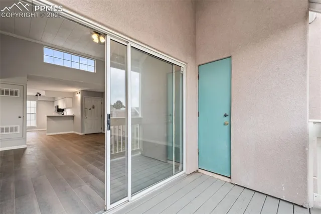 a view of a hallway with wooden floor