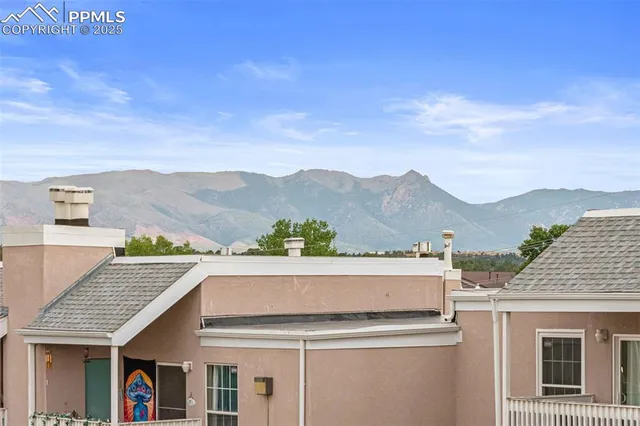 a view of a house with a balcony and wooden floor