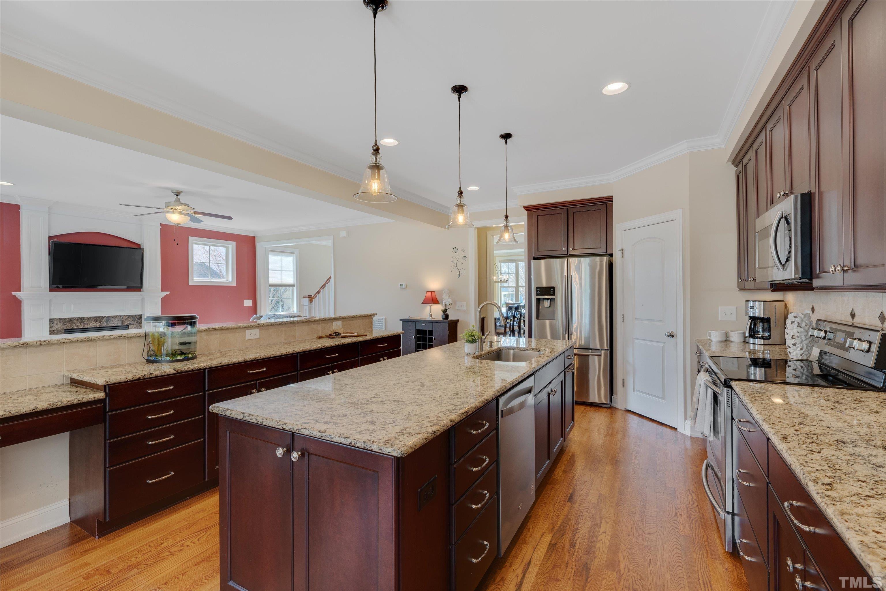 2704 Full Circle Raleigh, NC 27613 - Photo 11 of 32 a kitchen with granite countertop counter space a sink appliances and cabinets