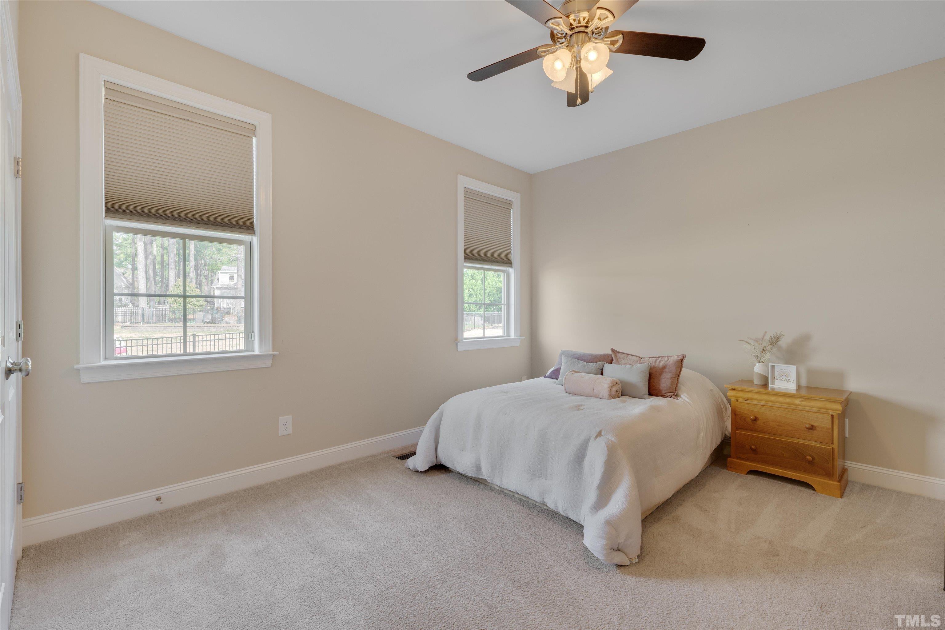 2704 Full Circle Raleigh, NC 27613 - Photo 14 of 32 a bedroom with bed and window