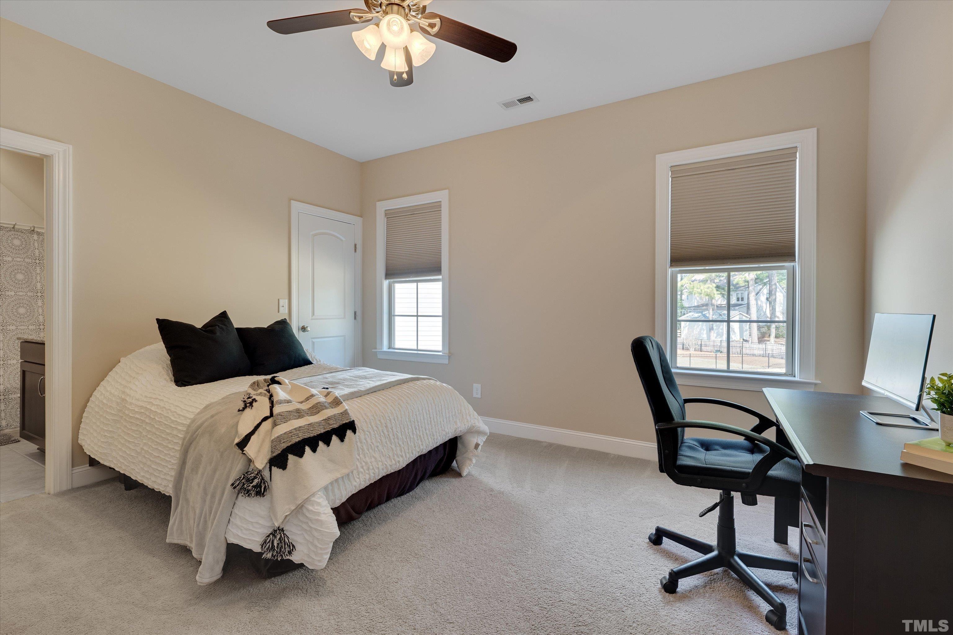 2704 Full Circle Raleigh, NC 27613 - Photo 21 of 32 a bed room with a bed tv and a window