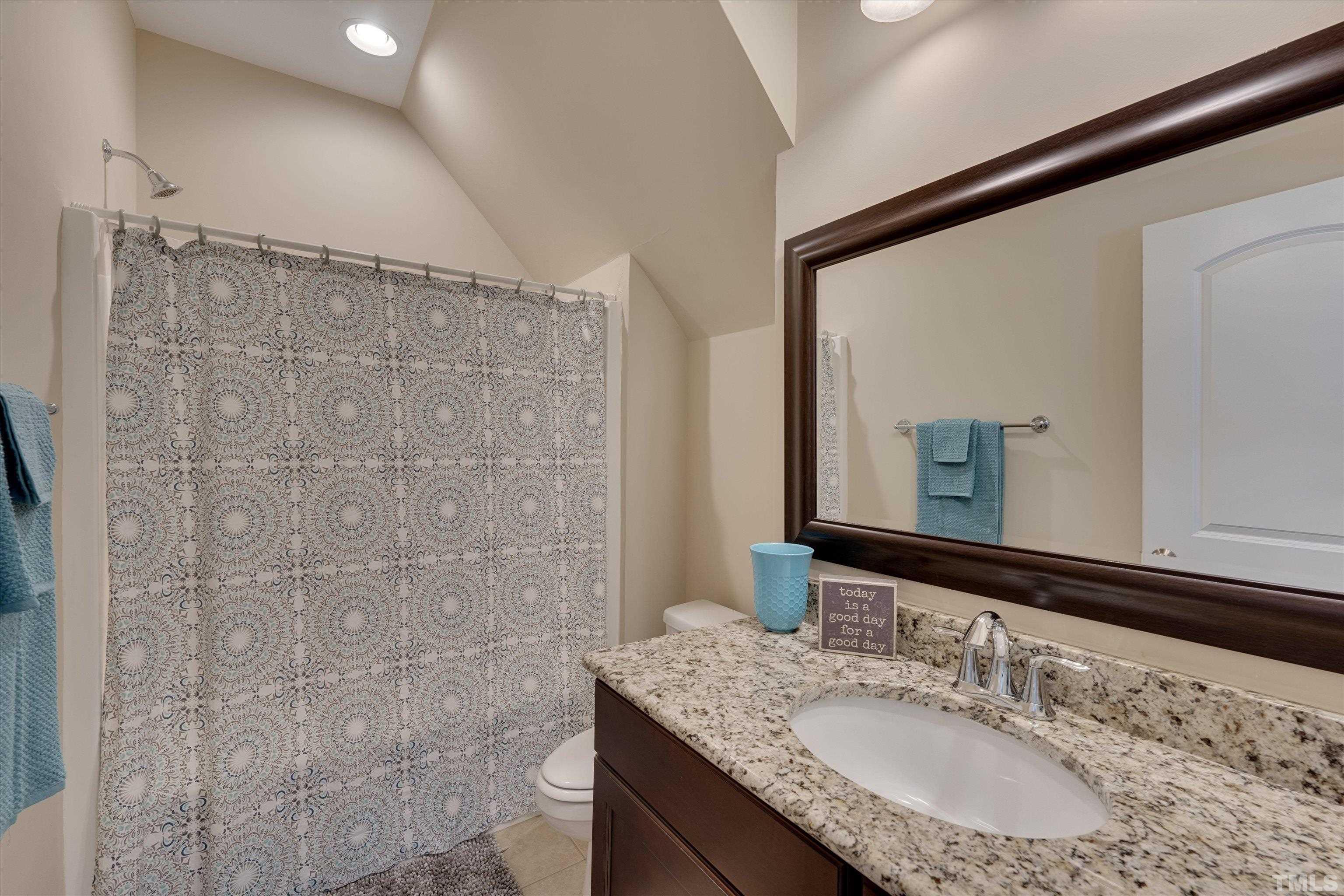 2704 Full Circle Raleigh, NC 27613 - Photo 22 of 32 a bathroom with a granite countertop shower sink and mirror
