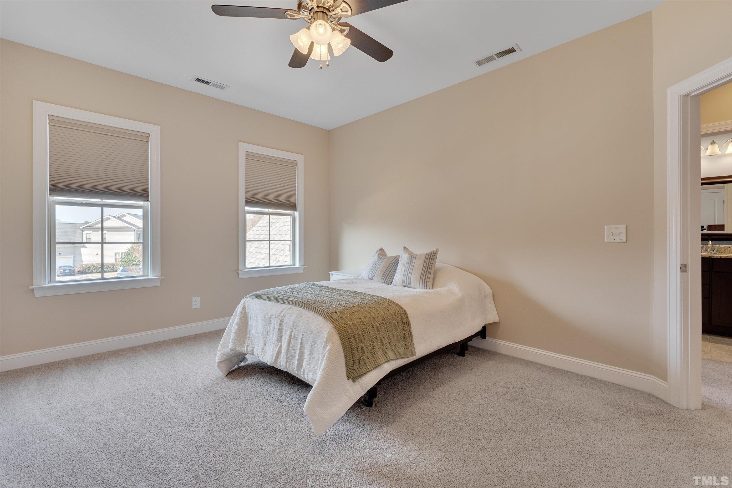 2704 Full Circle Raleigh, NC 27613 - Photo 24 of 32 a spacious bedroom with a bed and a window