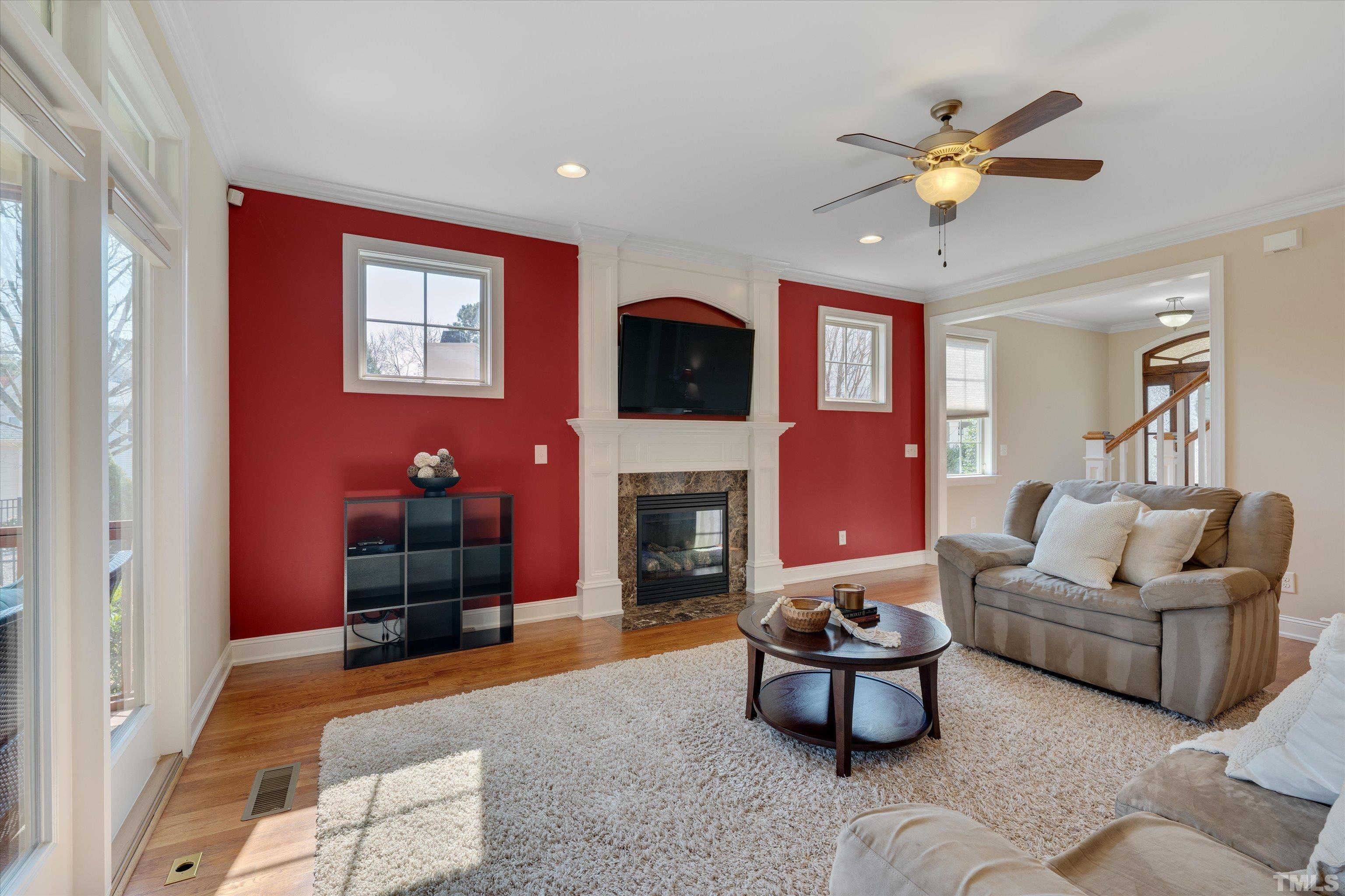 2704 Full Circle Raleigh, NC 27613 - Photo 7 of 32 a living room with furniture a fireplace and a flat screen tv