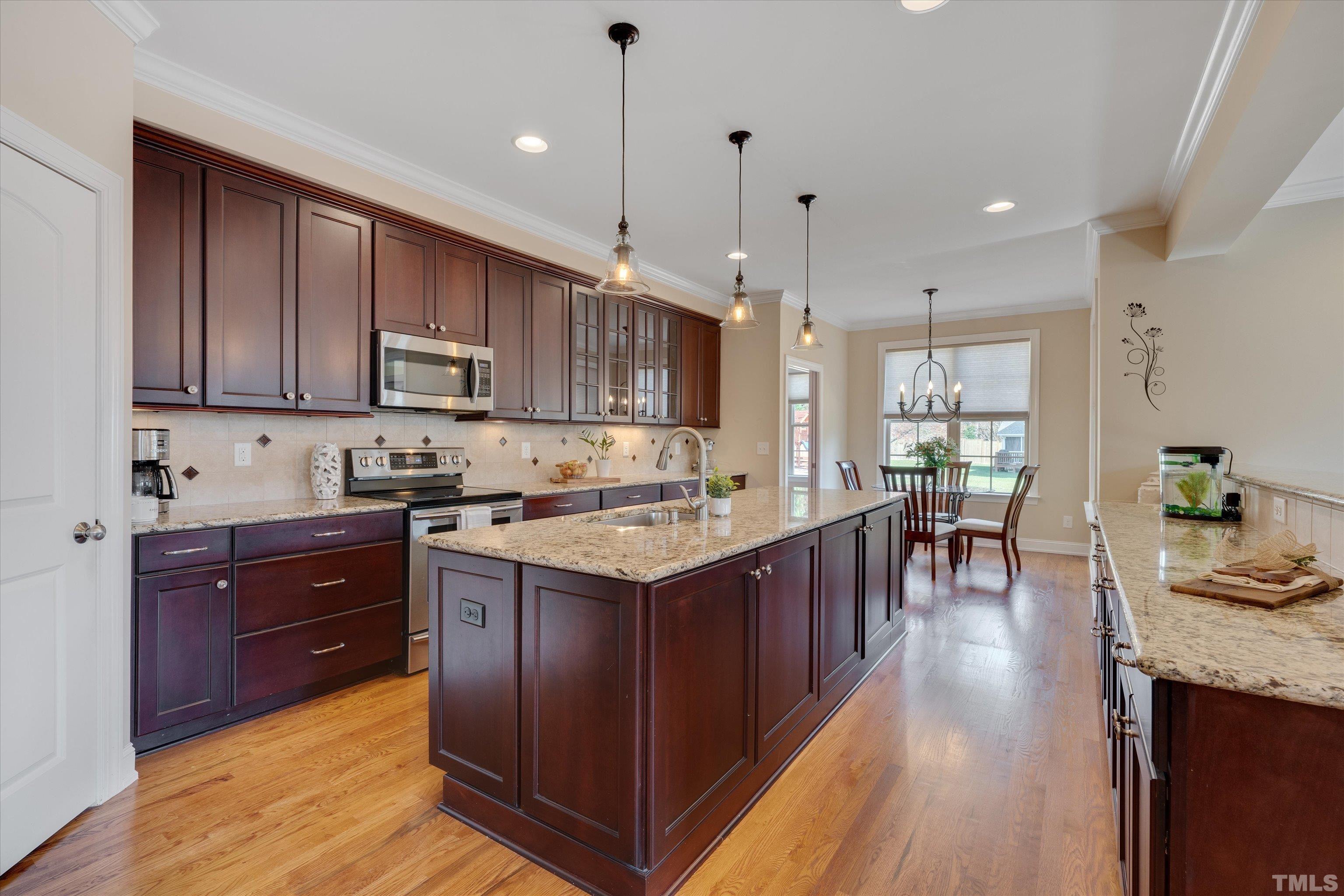 2704 Full Circle Raleigh, NC 27613 - Photo 9 of 32 a kitchen with a sink stove and wooden cabinets