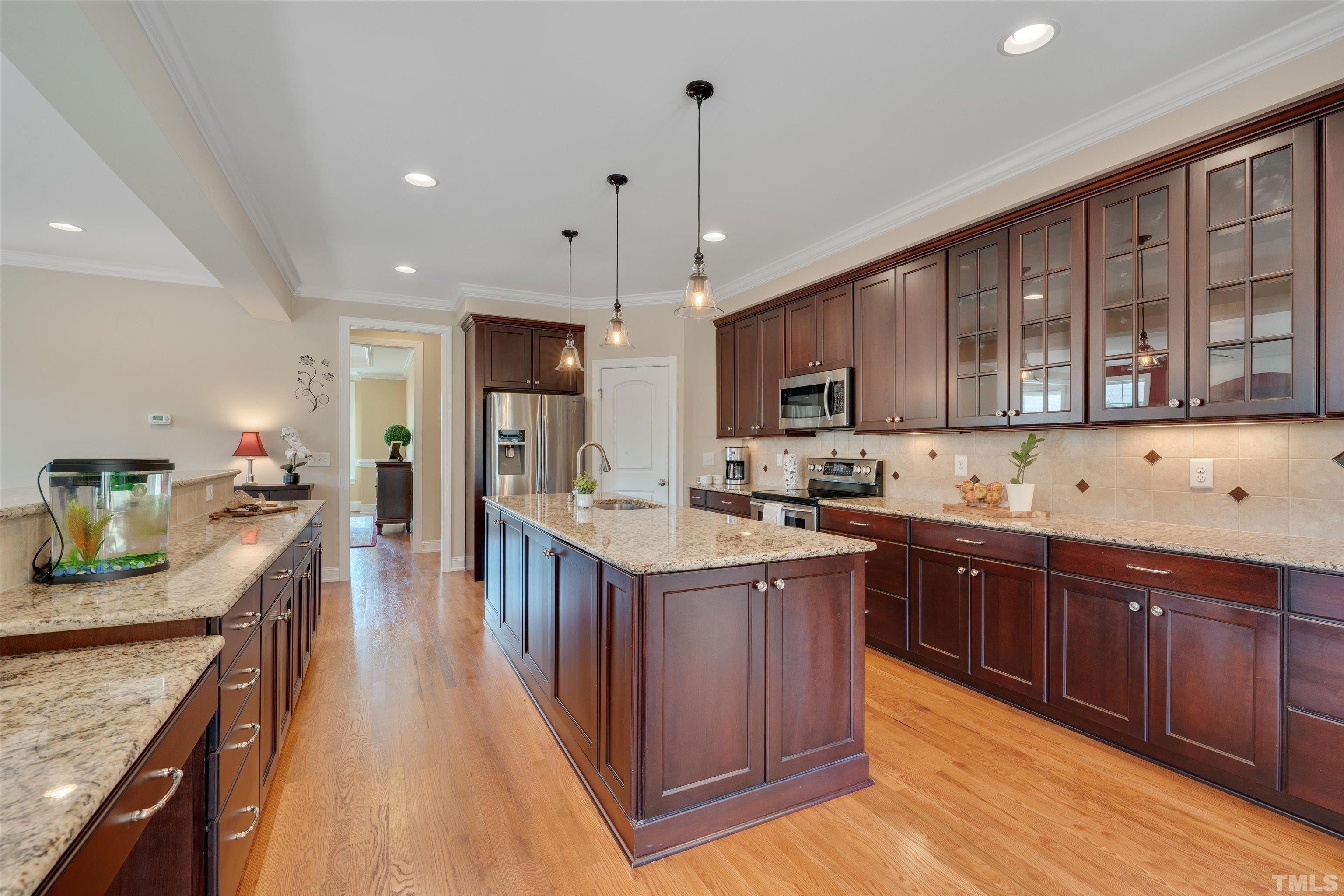 2704 Full Circle Raleigh, NC 27613 - Photo 10 of 32 a kitchen with stainless steel appliances granite countertop wooden cabinets a sink dishwasher a stove and a refrigerator