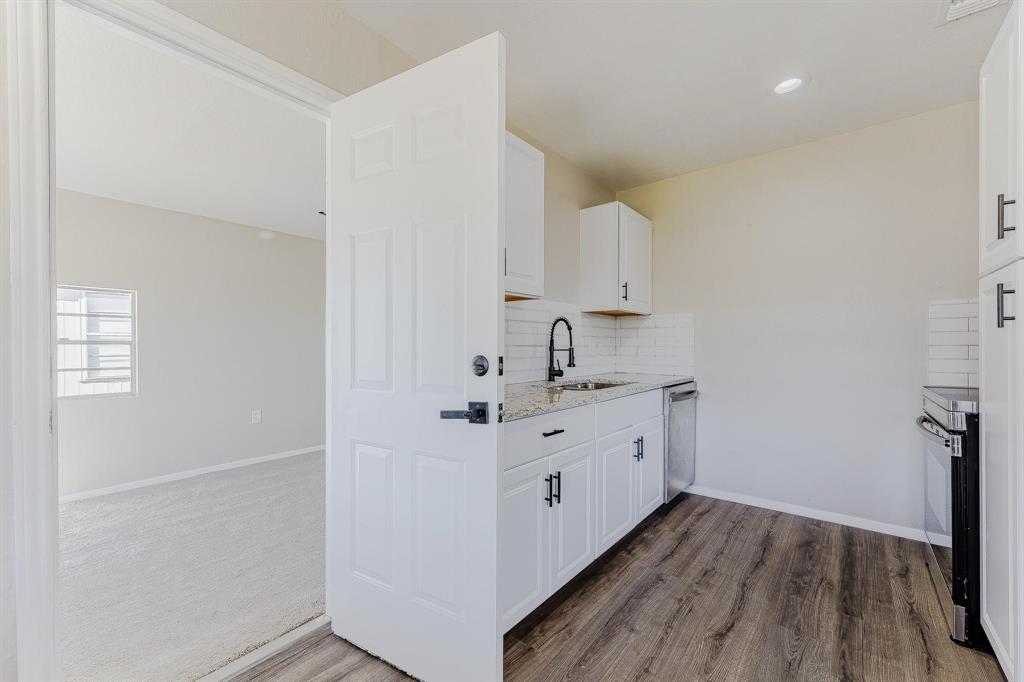 3305 Elm Grove Road Rowlett, TX 75098 - Photo 11 of 24 Kitchen featuring decorative backsplash, white cabinetry, light stone countertops, appliances with stainless steel finishes, and recessed lighting