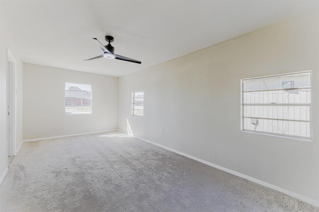 3305 Elm Grove Road Rowlett, TX 75098 - Photo 12 of 24 Spare room featuring carpet floors and ceiling fan