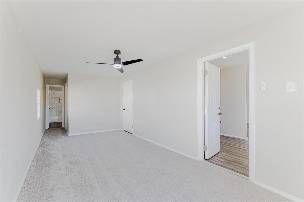 3305 Elm Grove Road Rowlett, TX 75098 - Photo 13 of 24 Unfurnished bedroom with connected bathroom, light colored carpet, and ceiling fan