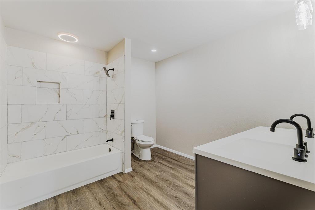 3305 Elm Grove Road Rowlett, TX 75098 - Photo 15 of 24 Bathroom with double vanity, shower / washtub combination, light wood-style flooring, and recessed lighting