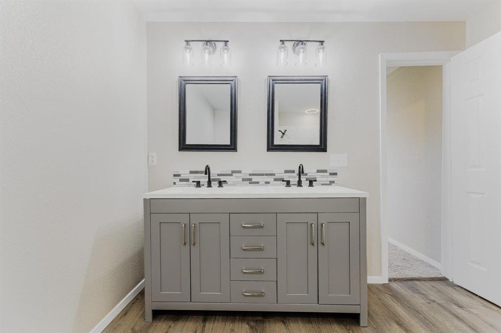 3305 Elm Grove Road Rowlett, TX 75098 - Photo 16 of 24 Full bathroom with double vanity, light wood-type flooring, and tasteful backsplash