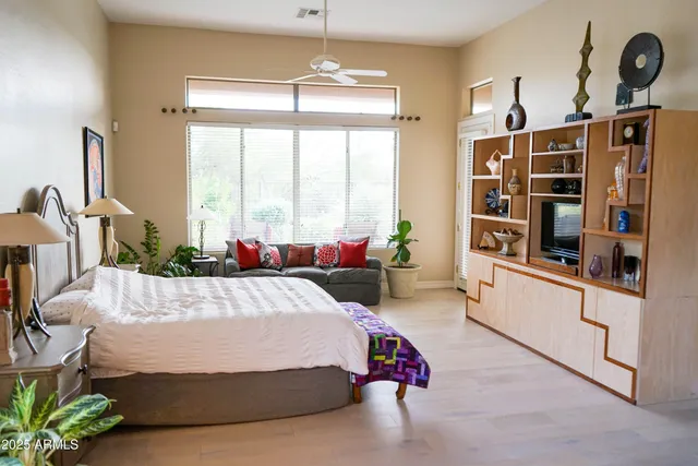 a bed room with a bed and a large window