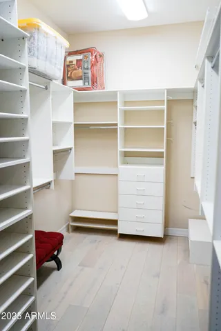 a view of walk in closet with empty racks