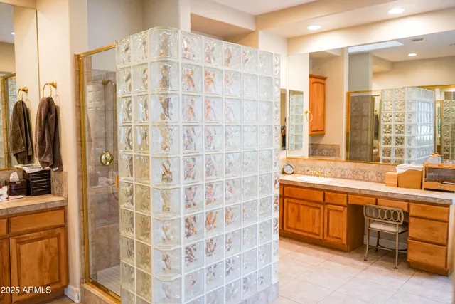 a spacious bathroom with a double vanity sink a mirror and a bathtub