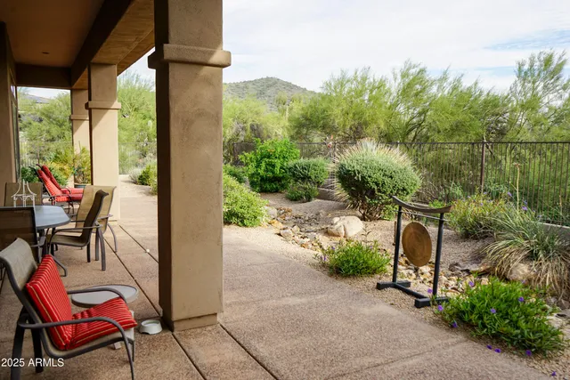a view of a patio with table and chairs and potted plants