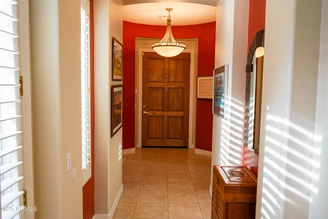 a view of a bathroom with a tub and chandelier