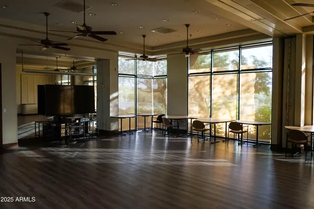 a living room with furniture large window and flat screen tv
