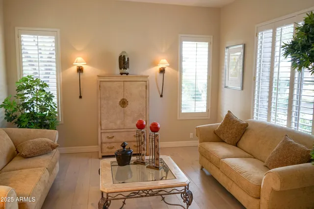 a living room with furniture and a potted plant