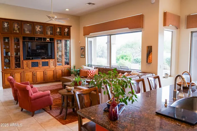 a living room with furniture and a floor to ceiling window
