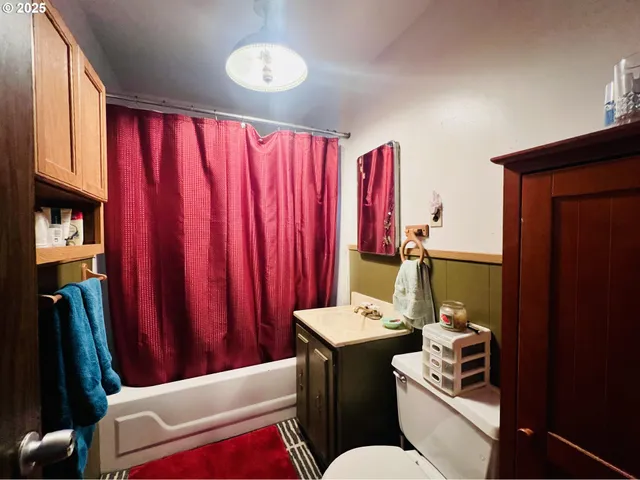 a living room with furniture a window and a flat screen tv