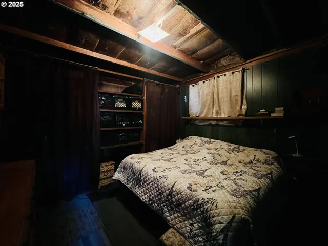 a bed sitting in a bedroom next to a window