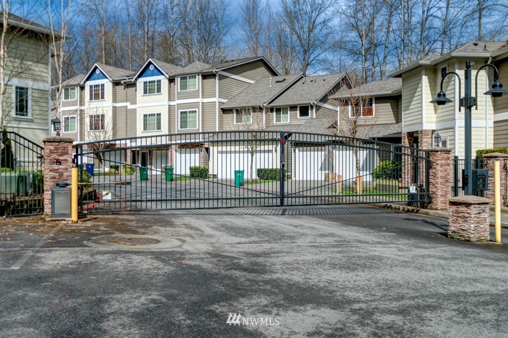 21228 11th Drive Southeast Bothell, WA 98021 - Photo 22 of 23 a view of a white house with large windows and a small yard