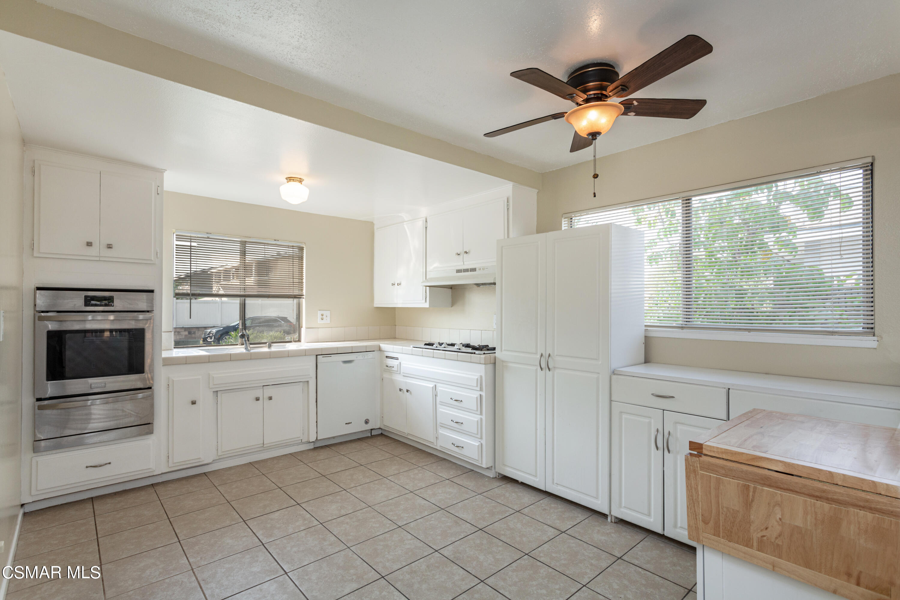 2291 Lysander Avenue Simi Valley, CA 93065 - Photo 8 of 25 a kitchen with white cabinets and white appliances