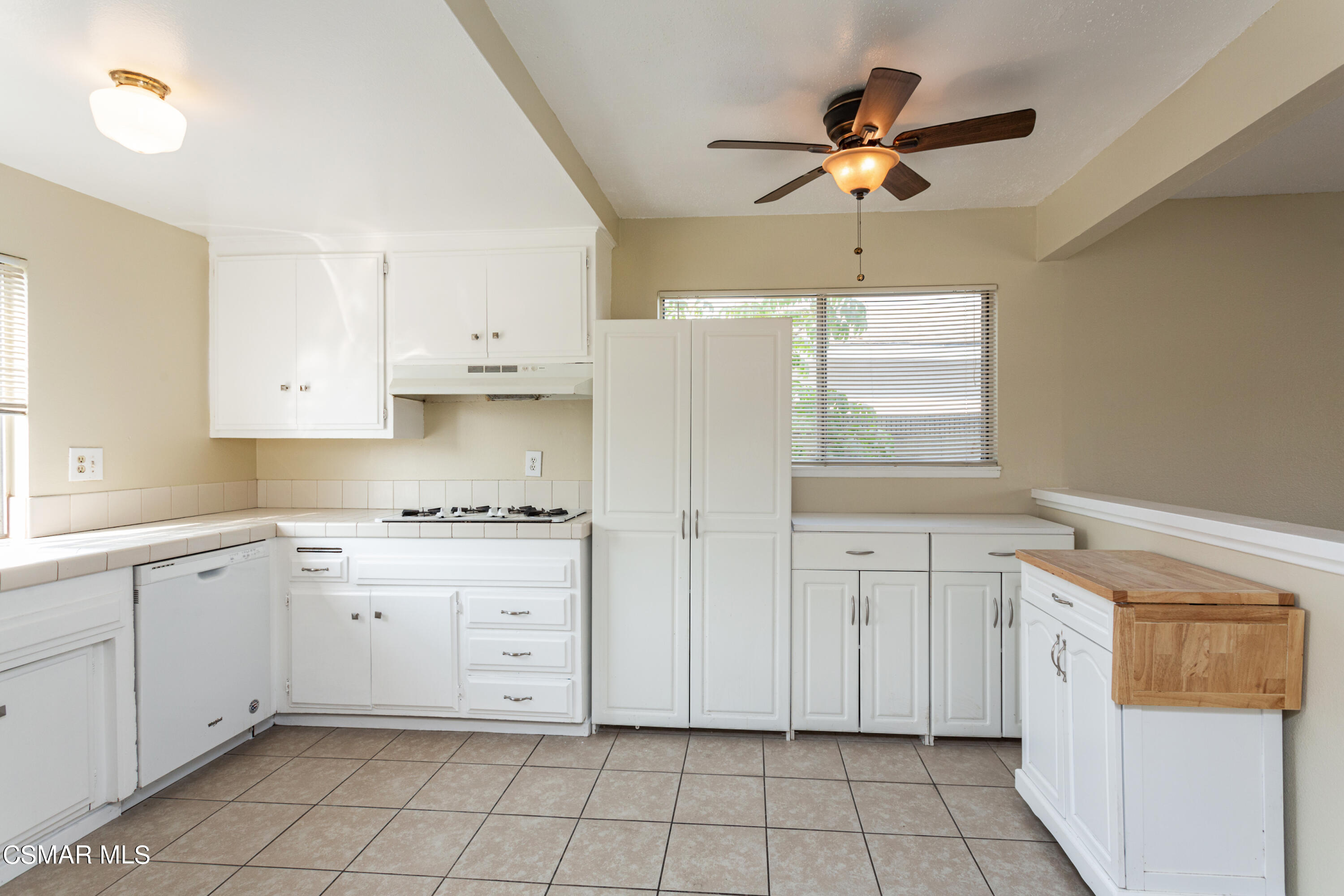 2291 Lysander Avenue Simi Valley, CA 93065 - Photo 10 of 25 a kitchen with white cabinets and white appliances