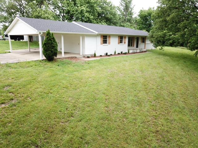 309 Butler Road Portland, TN 37148 - Photo 2 of 30 a front view of a house with a garden and yard