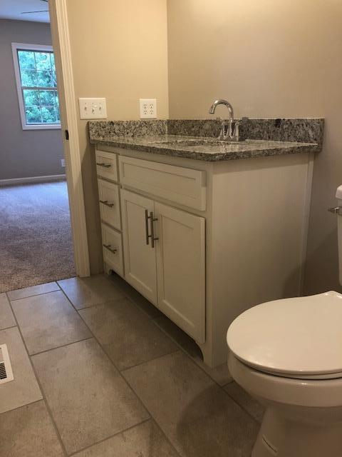 309 Butler Road Portland, TN 37148 - Photo 17 of 30 a bathroom with a granite countertop toilet sink and mirror