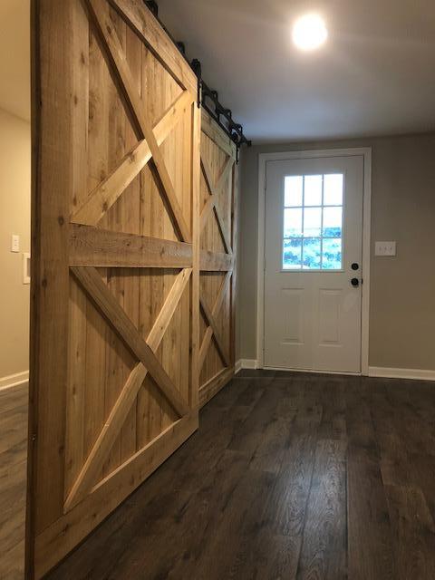 309 Butler Road Portland, TN 37148 - Photo 23 of 30 an empty room with wooden floor door and windows