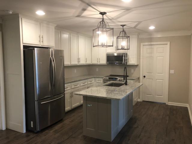 309 Butler Road Portland, TN 37148 - Photo 8 of 30 a kitchen with stainless steel appliances granite countertop a sink stove and refrigerator