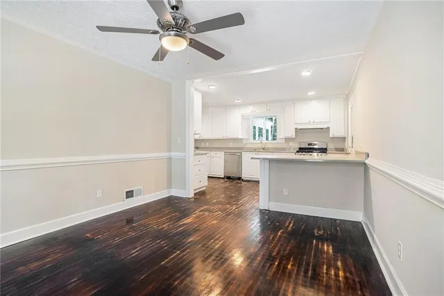 a view of kitchen with wooden floor electronic appliances and window