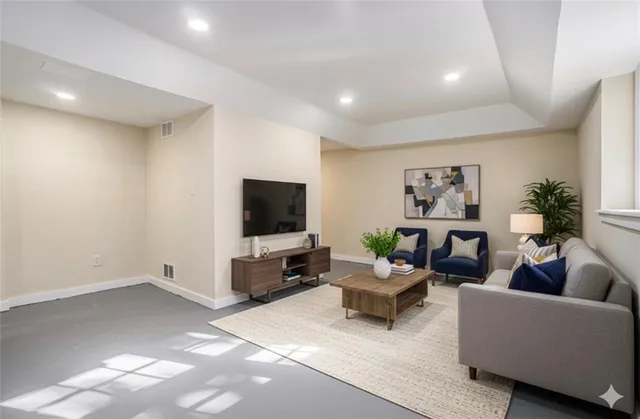 a living room with furniture and a flat screen tv